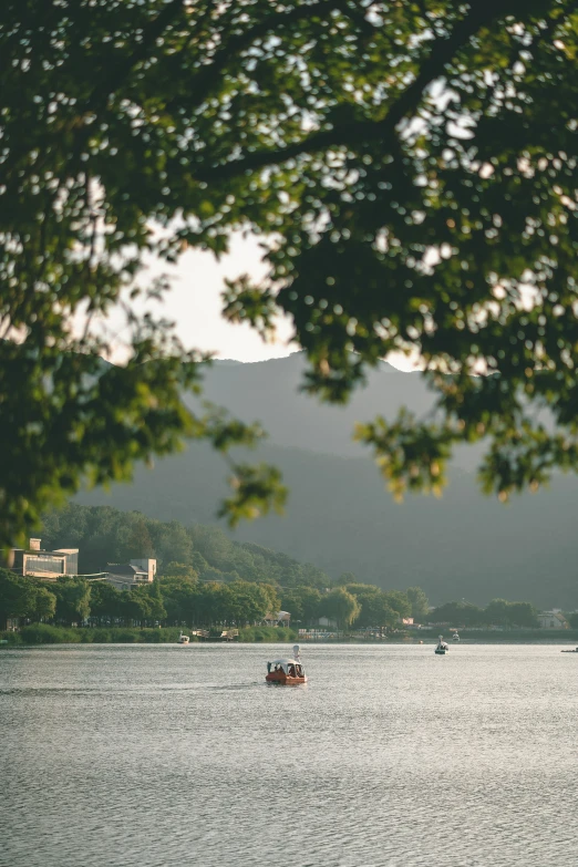 two people are rowing in a boat on the water