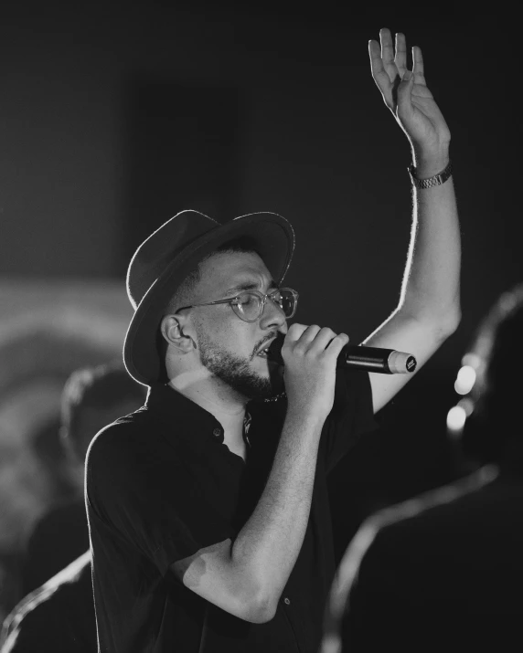 a man in a hat with his arms up