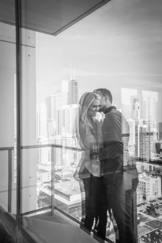 a man and woman standing on top of a building