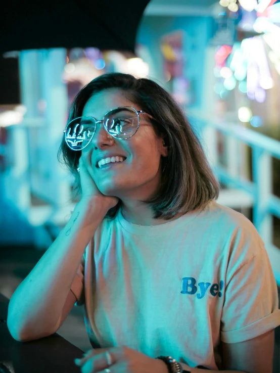 a woman with glasses looks over her shoulder