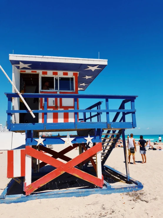 a lifeguard house with stars painted on it at the beach