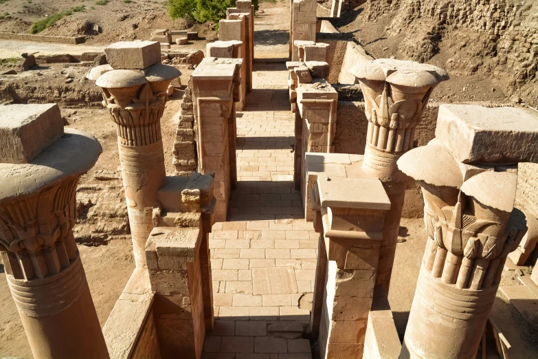 several very old statues sitting in a barren area