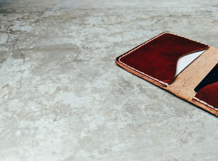 a small brown wallet with a computer mouse