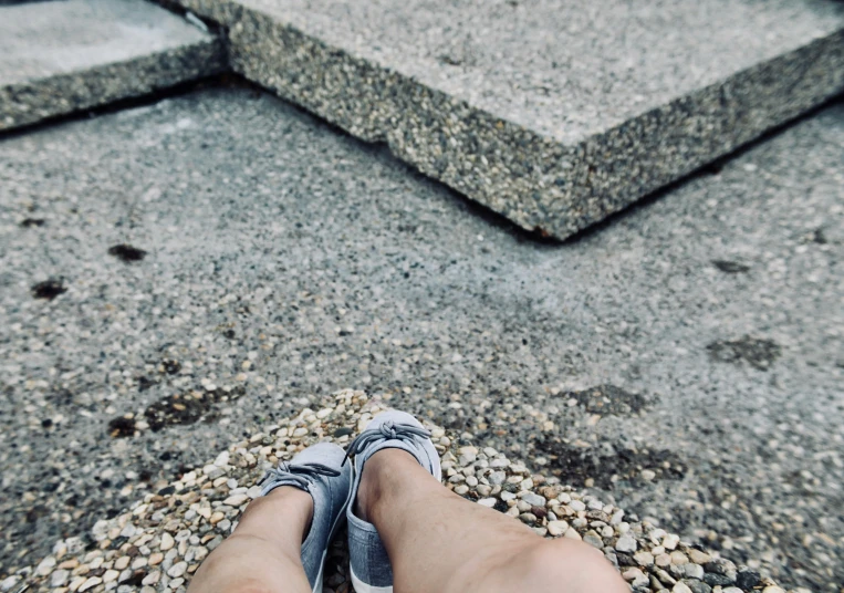 a person with their feet in the middle of a floor