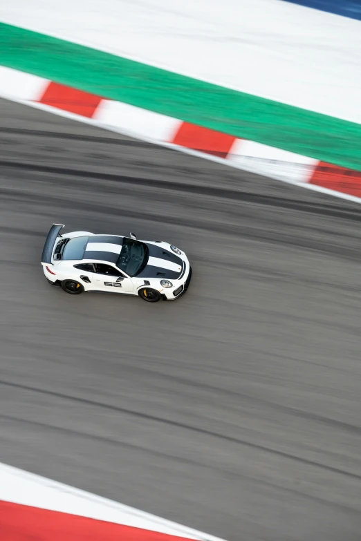 a racing car going around a corner in the street