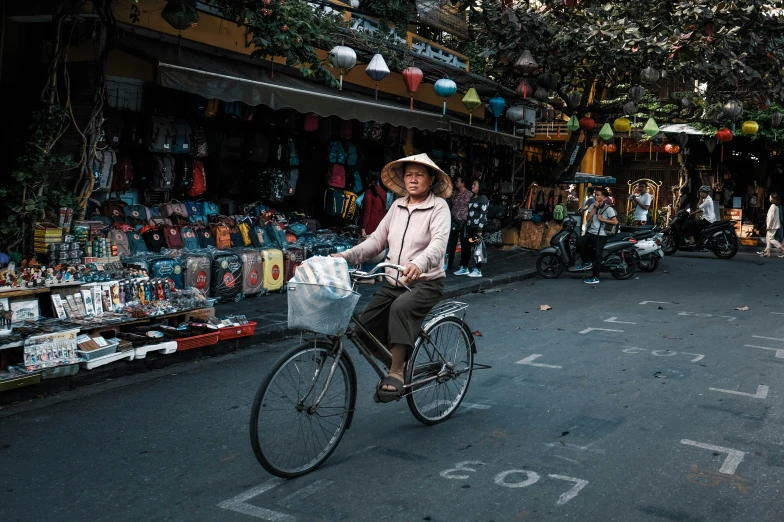 a woman riding a bicycle in a market