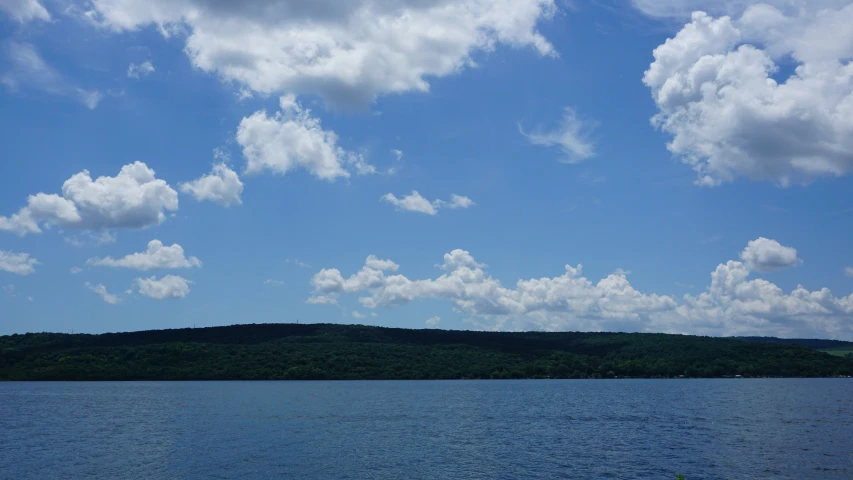 a body of water with clouds over it