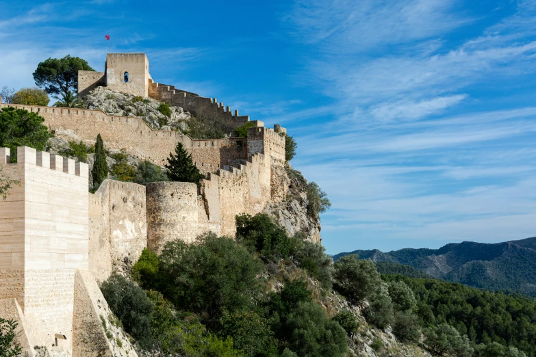 a very tall castle like structure on the side of a hill