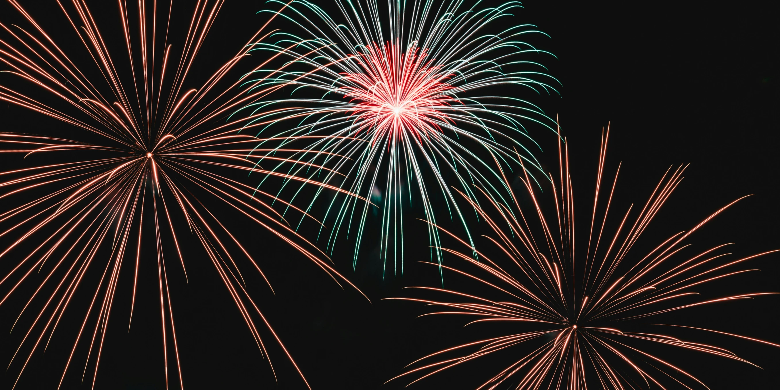 fireworks lit up the night sky with red, green and white streaks