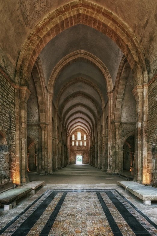 an old building with stone walls and a large archway