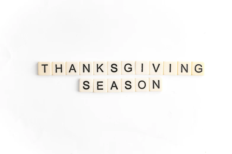 scrabble tiles spelling thanksgiving season with blocks spelling out words