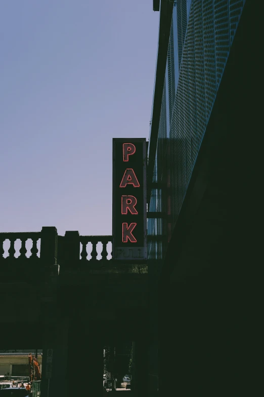 a black and white po with a pink park neon sign