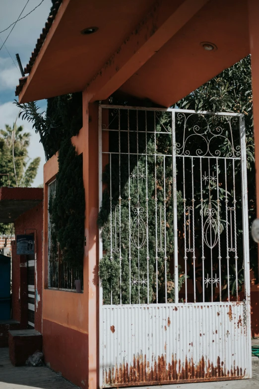 a doorway with a wrought iron gate that is missing the top portion