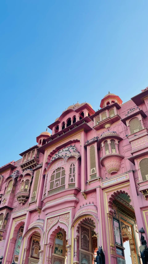 the entrance to a pink building at the city palace