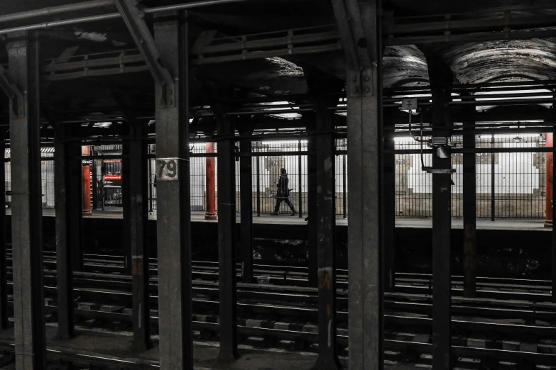 train tracks in an empty train station in the dark