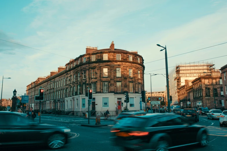 there is traffic on the road at dusk in this city