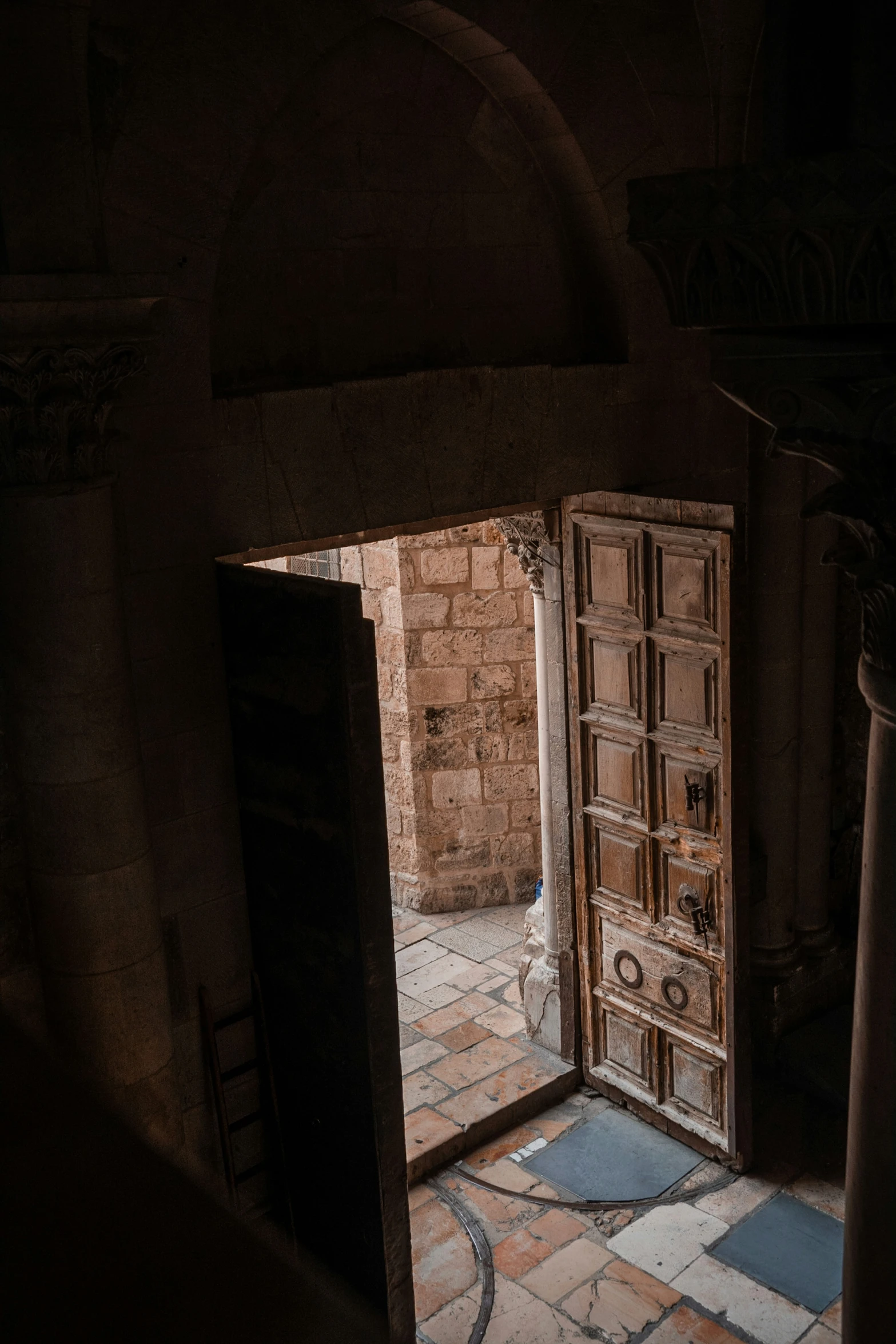 an open doorway with wooden doors and light