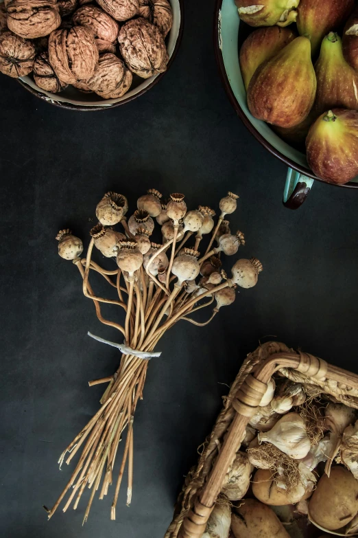 a bunch of mushrooms are in bowls next to a basket