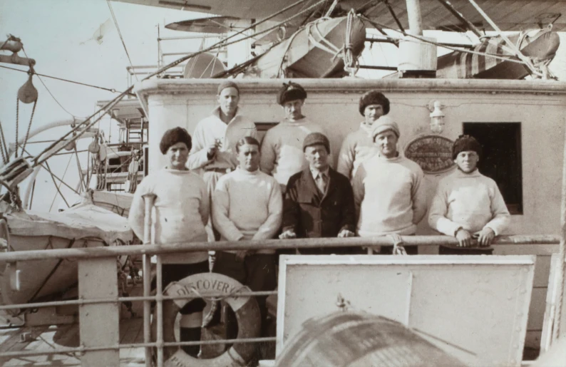 an old picture of men posing for a group po