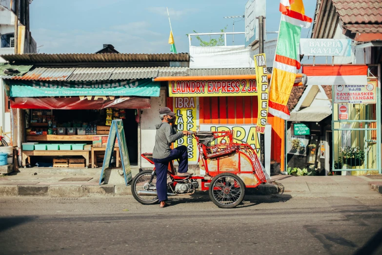 a man on a bicycle is near a building