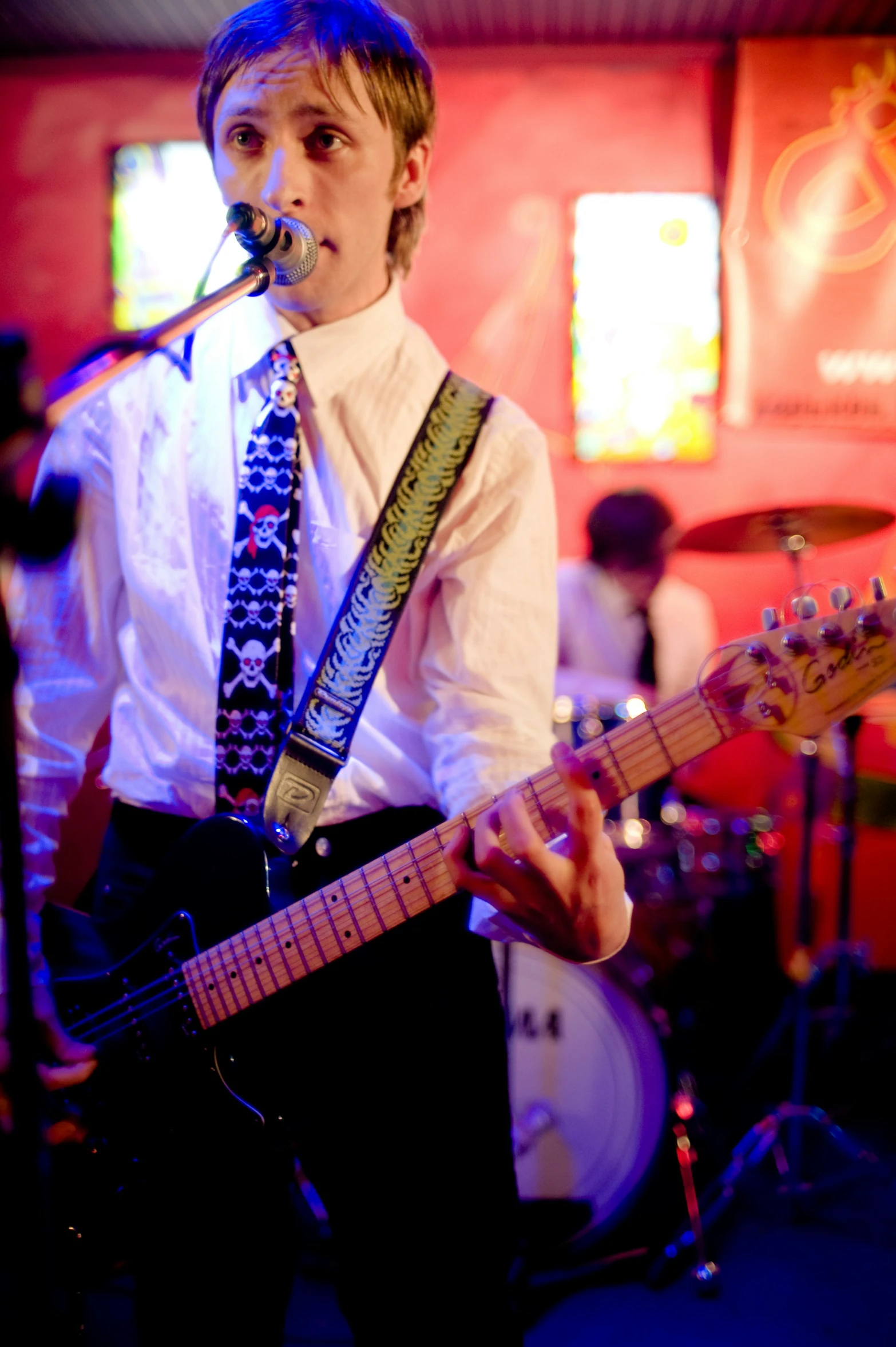 a man with a guitar on stage