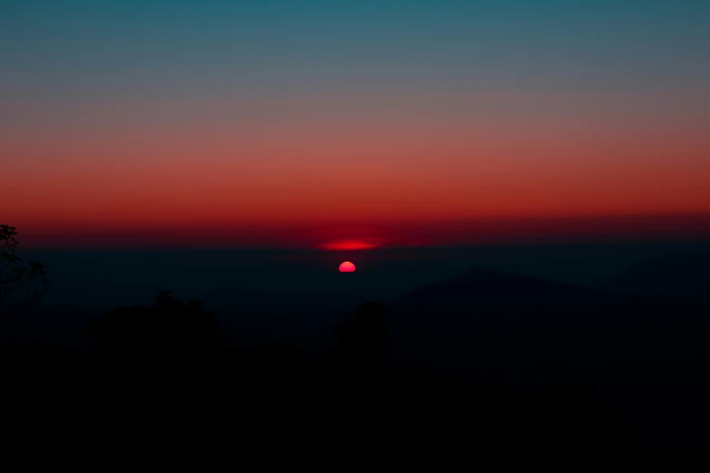 a dark sunset with bright orange and red colors