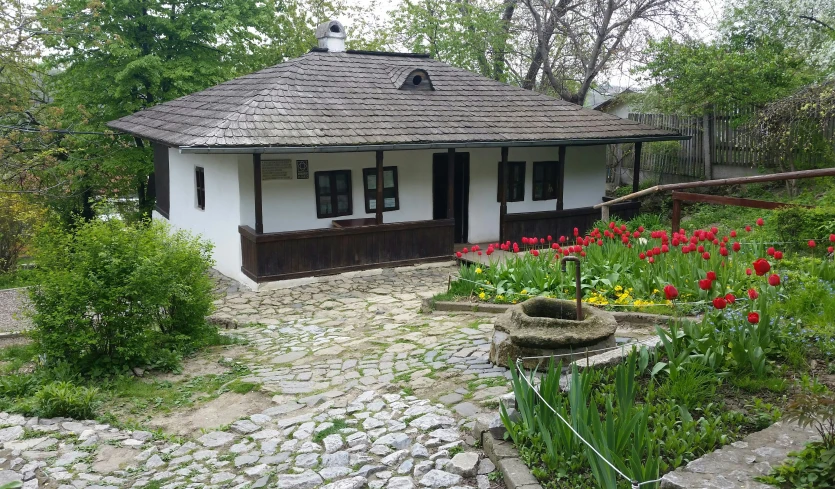 a home with a pathway near a flower bed