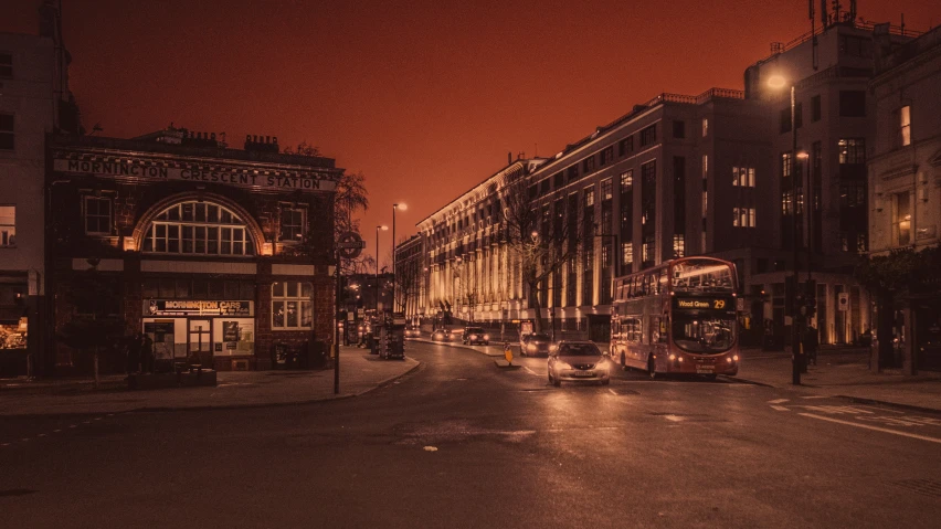 a view of a street at night with double decker buses on it