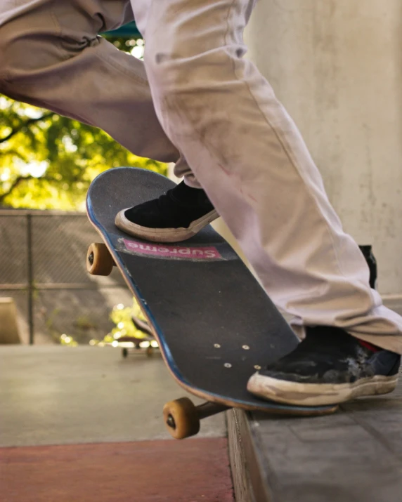 the feet and skateboard of a person on a ramp