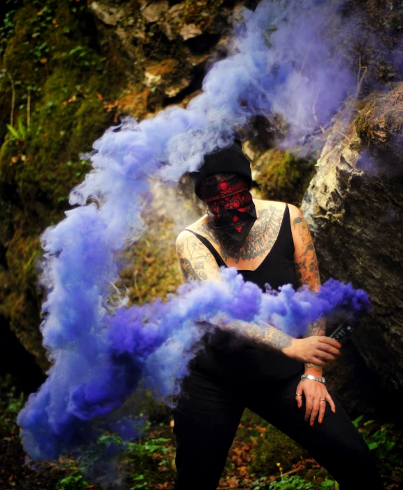 a man in black and red mask smoking smoke