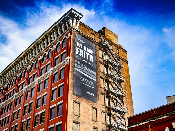 a tall brick building with a sign and words on it