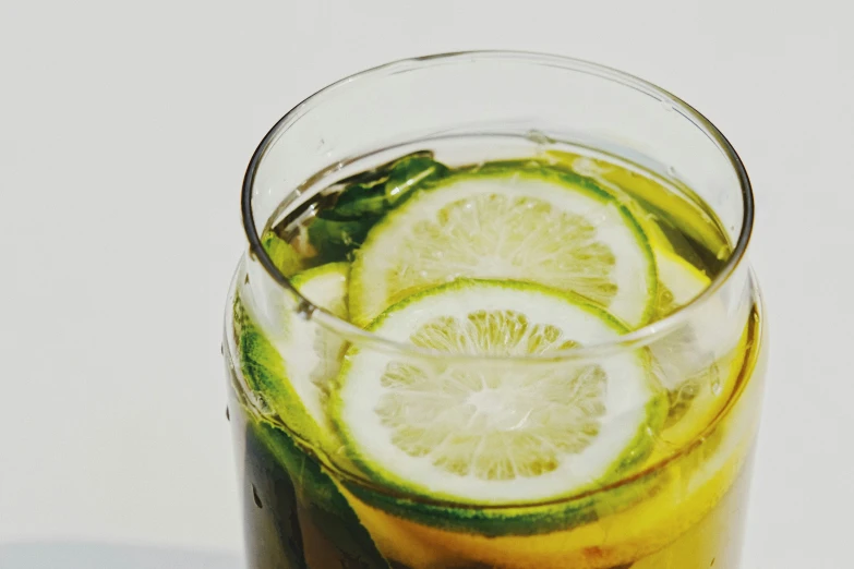 a drink is garnished with slices of lemon and lime