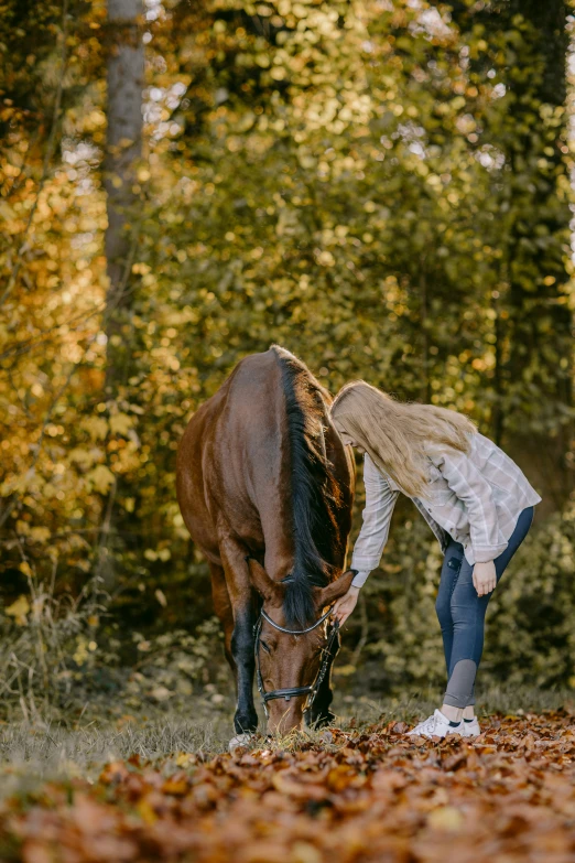 the young lady has her horse standing close to it