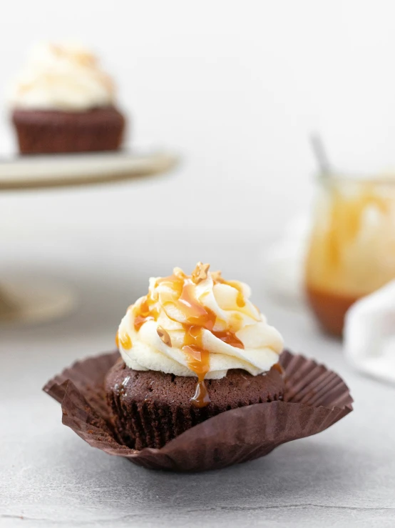 a cupcake topped with chocolate and orange icing