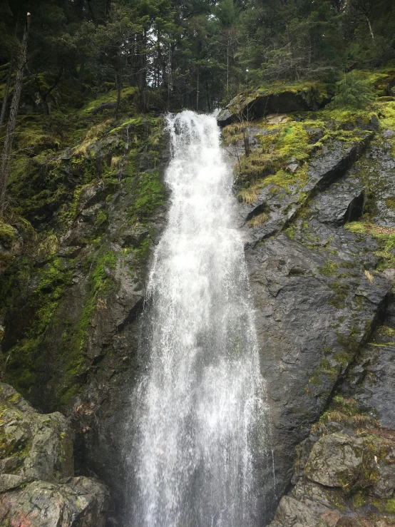 a water fall on the side of a rocky mountain