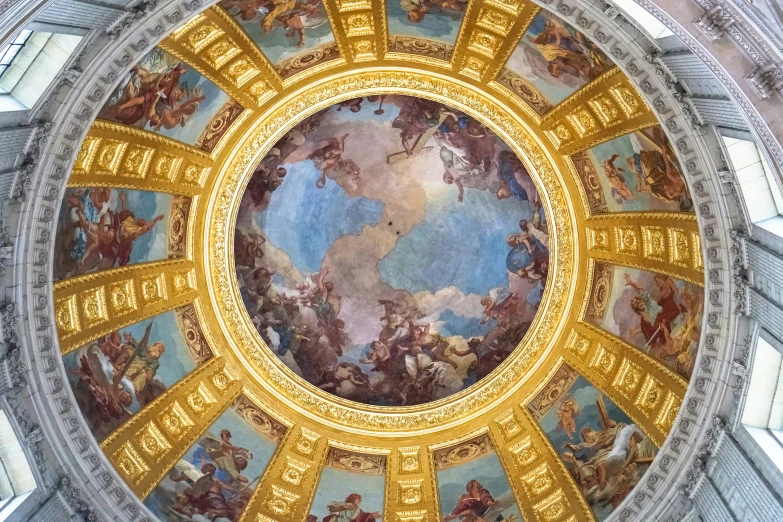 the ceiling of the building is painted with gold paint