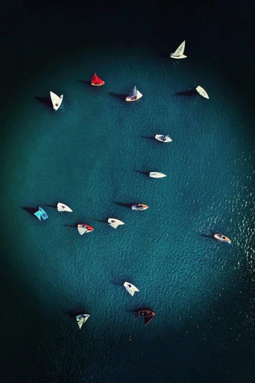 a group of small boats floating in blue water