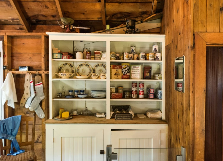 a kitchen cupboard with a bunch of food items on the shelves