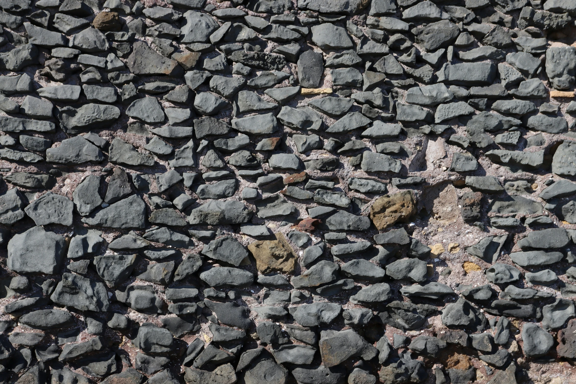 black rocks are next to each other with some brown