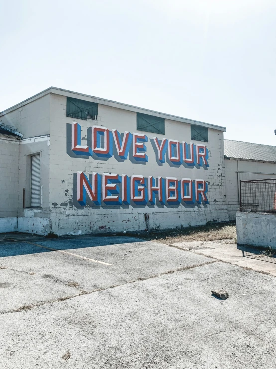 a very large building with an i love your neighbor sign