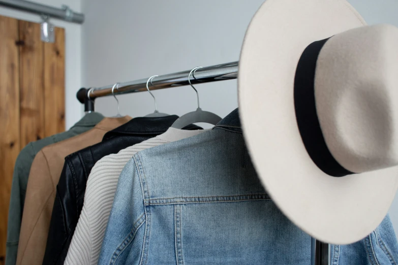 a hat sits on top of an open jacket rack