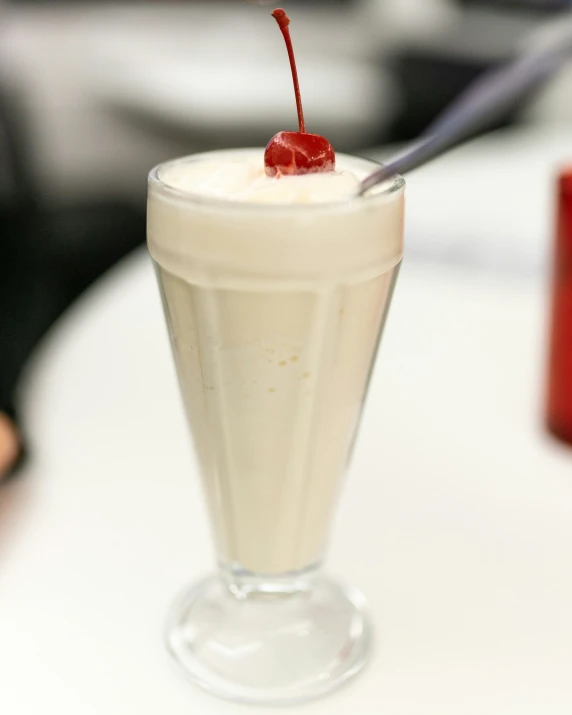 a drink with cream and a cherry on the top