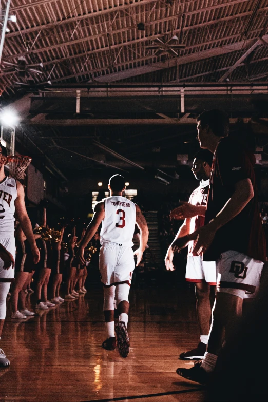 a basketball team walks onto the court