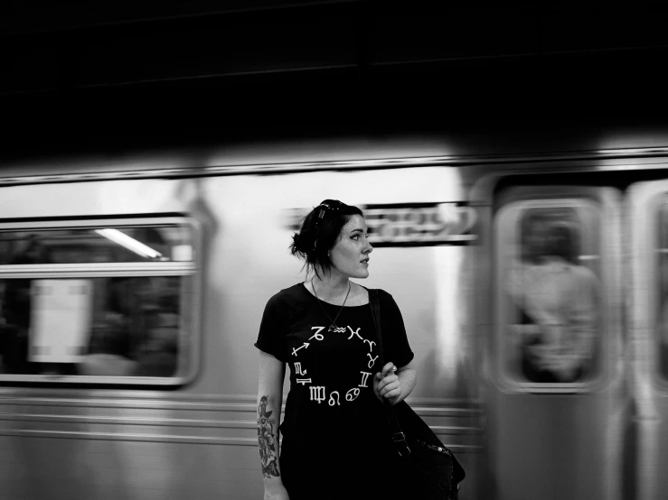 the young lady in black is waiting for her subway