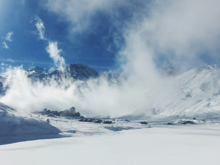 clouds and steam bill from the top of snow capped mountains