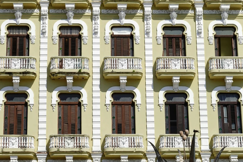 a tall building with many windows and balconies