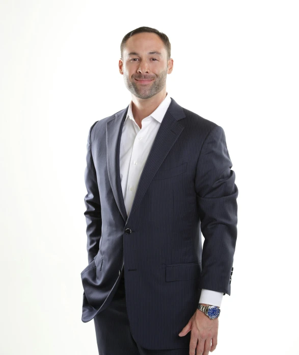 man wearing a suit and tie in front of a white background