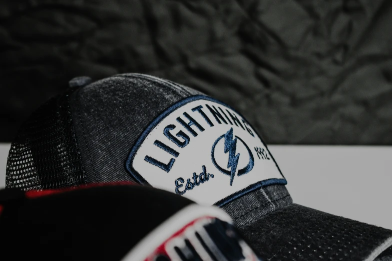 the back of a hat with light blue letters on it