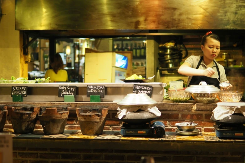 the chef is working behind the counter of a store