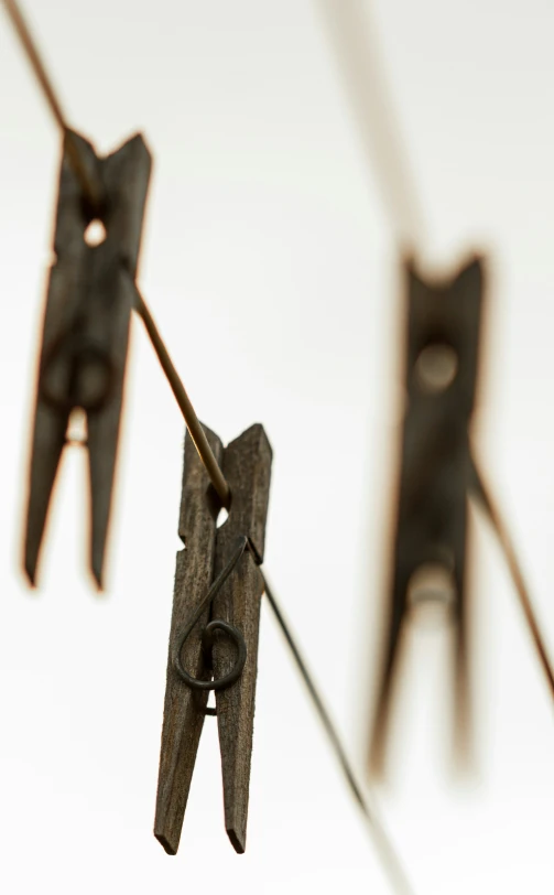 several pieces of metal hanging from a clothes line